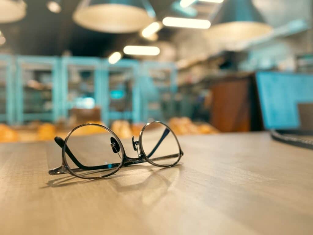 Na stole w kawiarni leżą okulary progresywne.